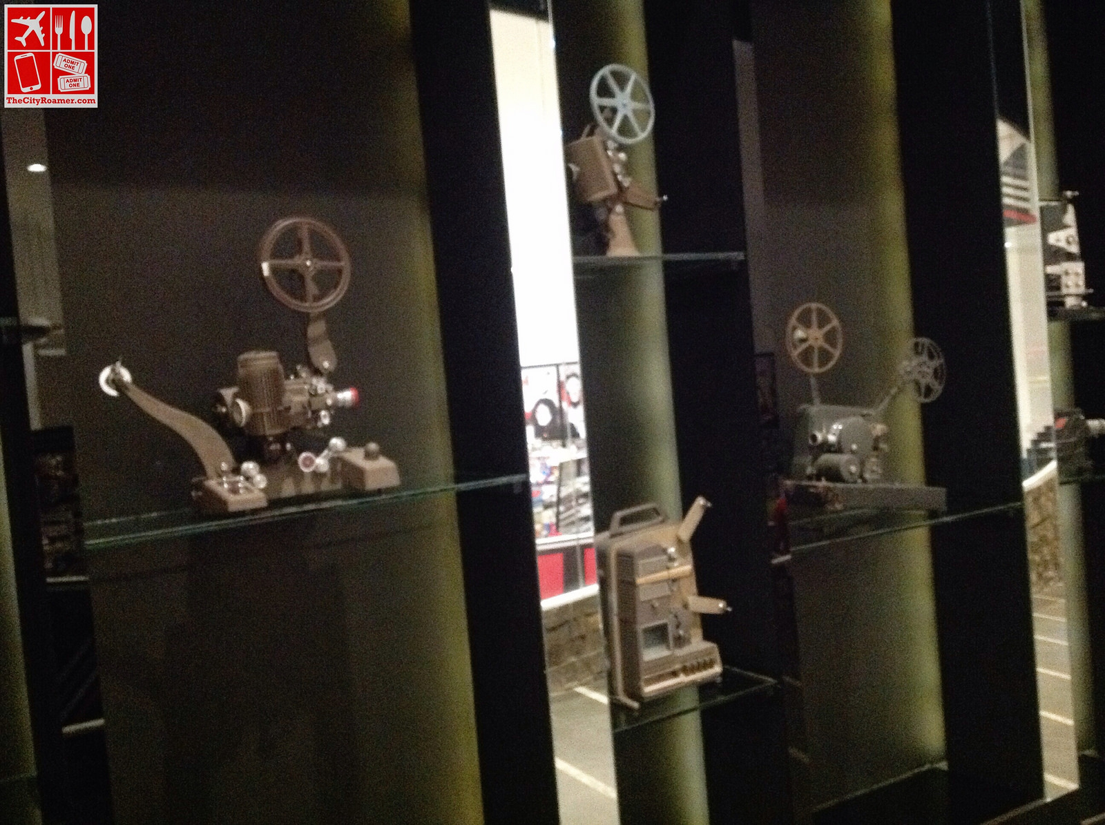 A collection of vintage reels displayed on a wall of Greenhills Cinemas